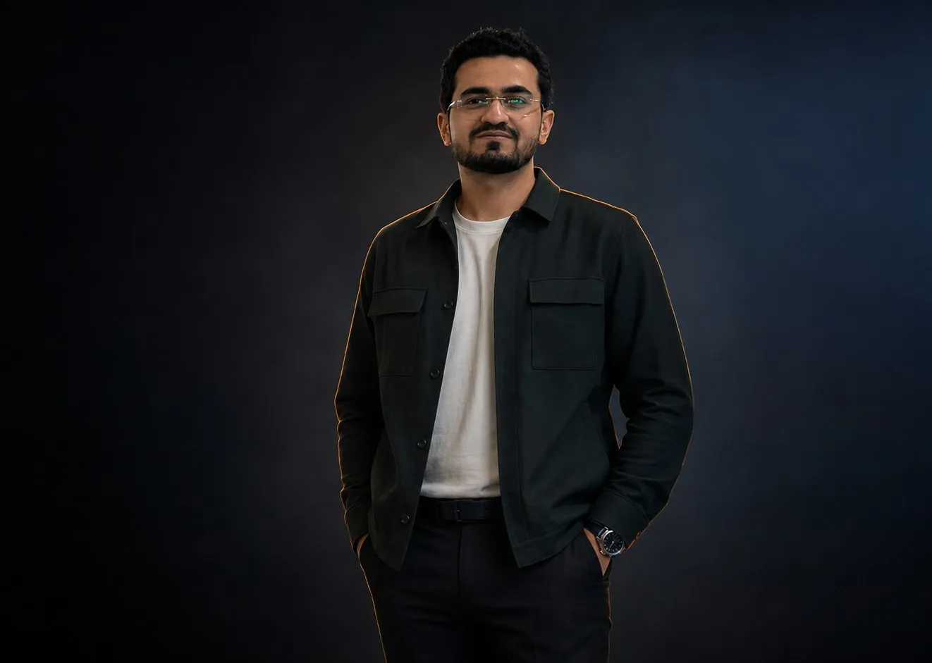 Talha Ansari, portrait in a dark studio